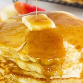 close up of apple cider syrup on pancakes