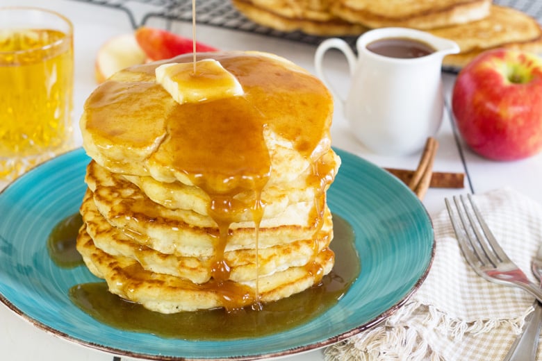 fluffy pancakes with syrup on a breakfast table 