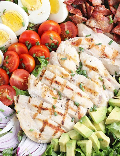 close up of sliced chicken on cobb salad