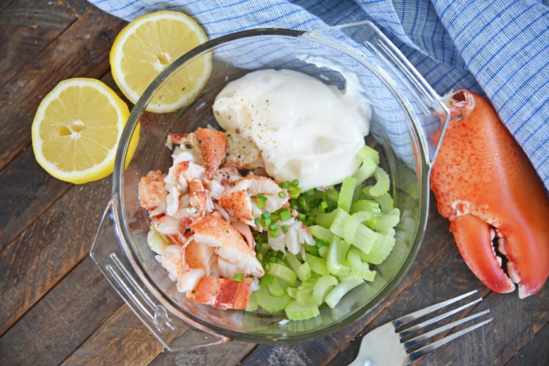 ingredients for lobster salad in a glass mixing bowl 
