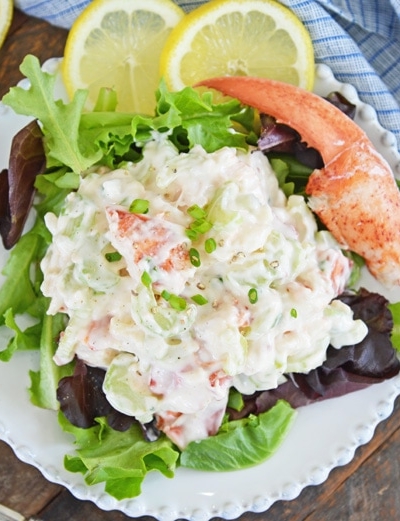 overhead of cold lobster salad on a plate with greens