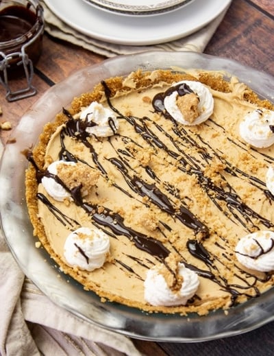 angle of peanut butter pie with whipped cream topping
