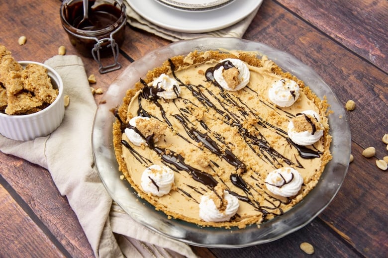 angle of peanut butter pie with whipped cream topping
