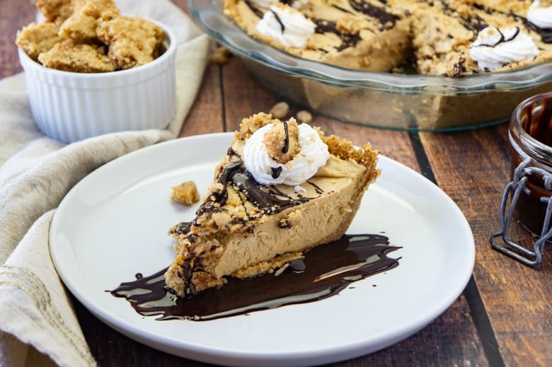 slice of peanut butter pie drizzled with fudge sauce 