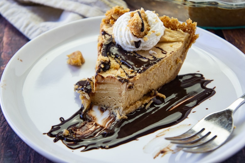 slice of peanut butter pie with whipped cream and fudge sauce 