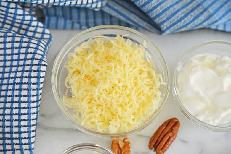 shredded gouda cheese in a small glass bowl 