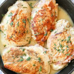 overhead shot of ham stuffed chicken in skillet