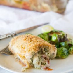 italian stuffed chicken on plate with brussels sprouts