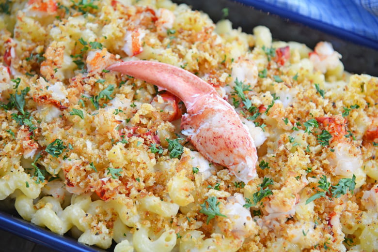 baked lobster mac and cheese with panko topping in a blue baking dish 