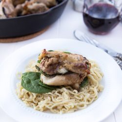 stuffed chicken pocket over pasta in a bowl