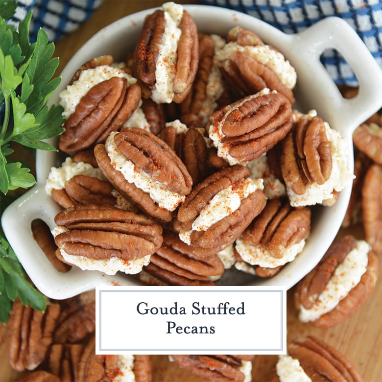 small white bowl of pecans sandwiches with gouda spread and dusted with smoked paprika 