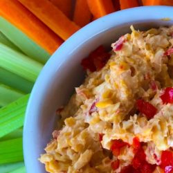 overhead shot of pimento dip with celery and carrots