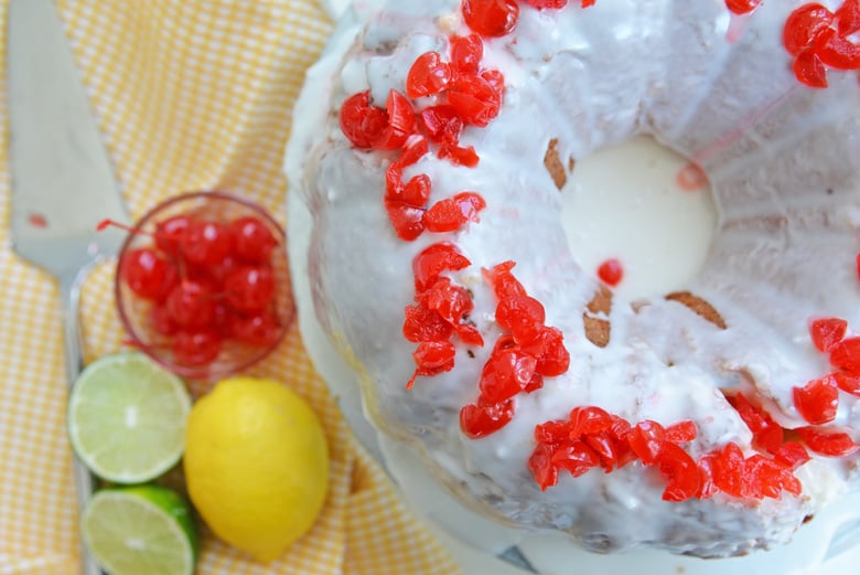 overhead of shirley temple style cake with lemon, lime and cherries  