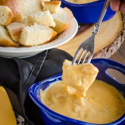 bread dipping into cheesy seafood dip