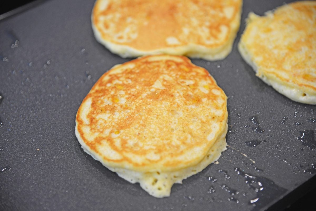 browned corn cake on a flat top grill 