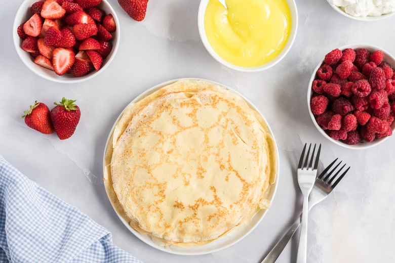 pile of crepes on a white plate 