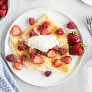 overhead of whipped cream and crepes