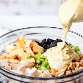 dressing pouring onto salad