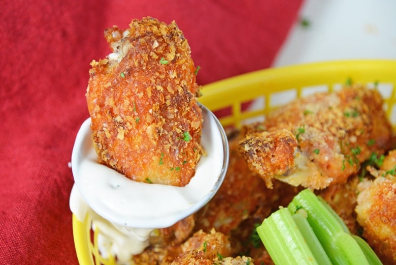 chicken wing dipping in blue cheese 