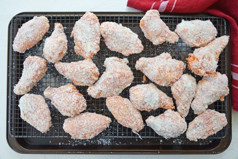 breaded chicken wings on wire rack 