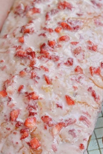 A close up of load pound cake with strawberry glaze