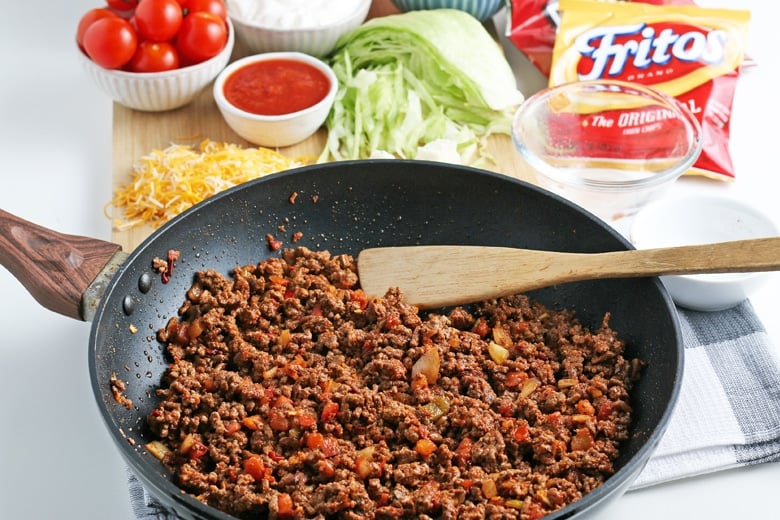 angled shot of wooden spoon in pan of taco meat