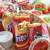four walking tacos in a basket