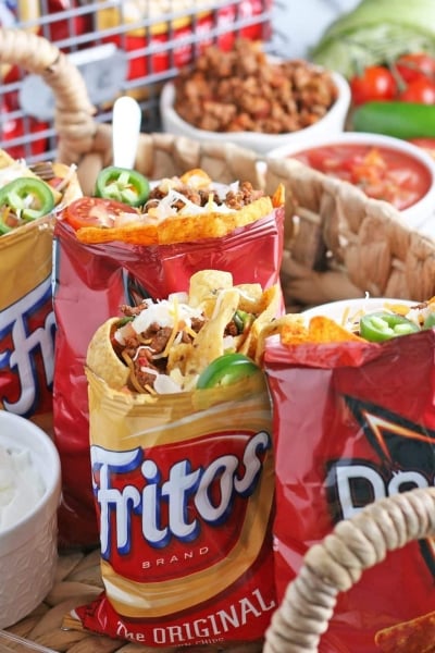 four walking tacos in a basket