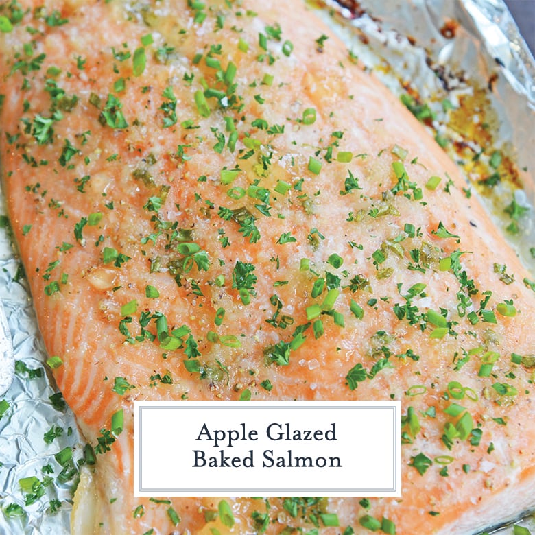 Close up of baked salmon on foil with chives and parsley 