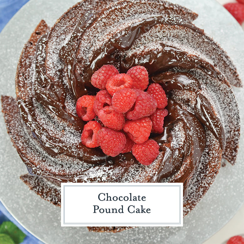 overhead view of chocolate pound cake with fudge sauce, powdered sugar and fresh raspberries 