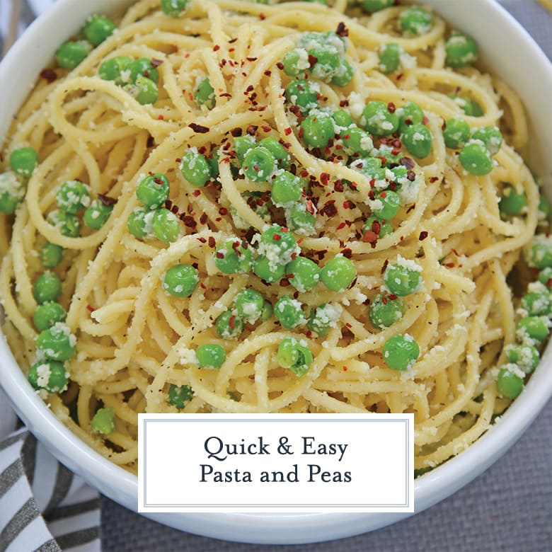 close up of spaghetti with peas topped with cheese 