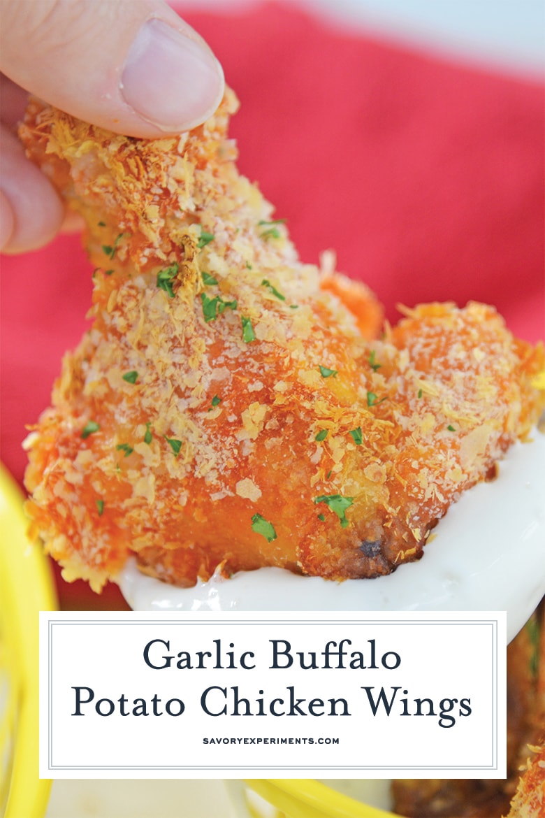 close up of breaded chicken wing dipping into sauce 