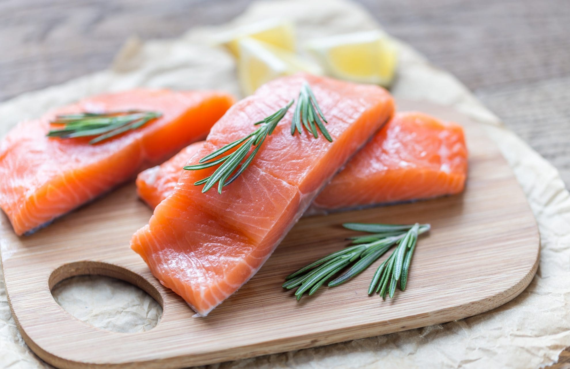 raw salmon on a cutting board 