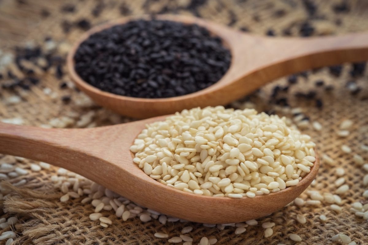 spoons of white and black sesame seeds