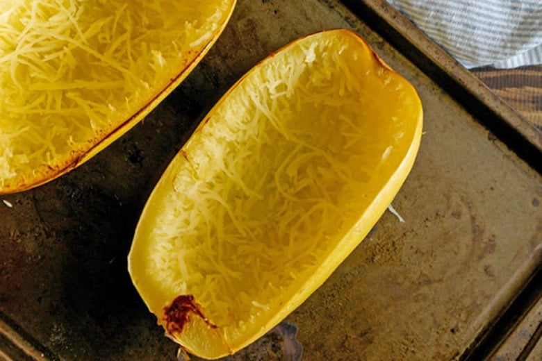 spaghetti squash halve on a baking sheet 