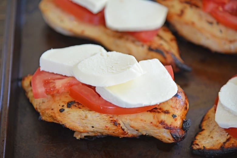 chicken topped with mozzarella cheese and tomatoes 