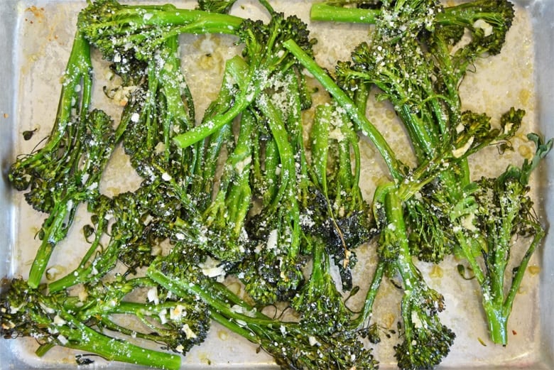 garlic parmesan broccolini on a baking sheet 