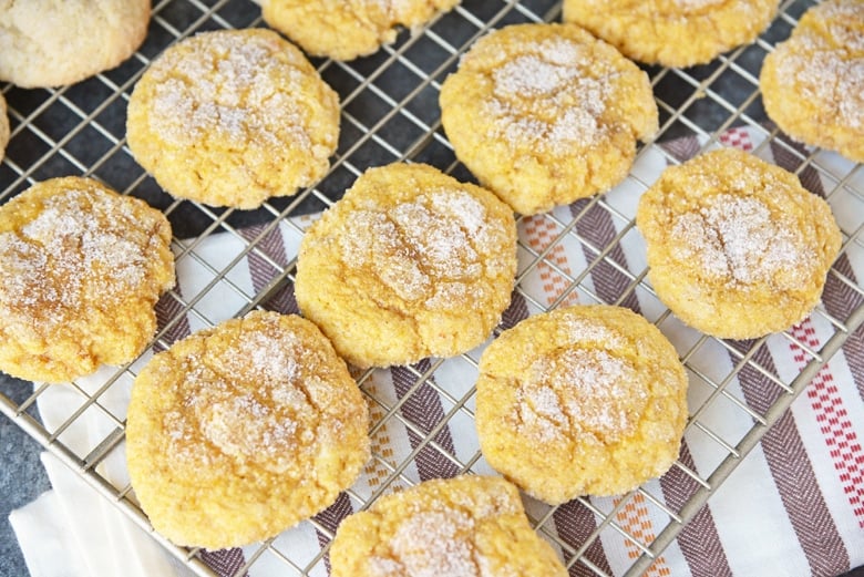 sugared pumpkin cookies on a wire rack 