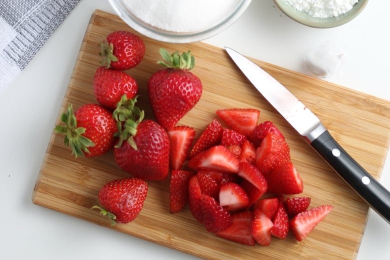 strawberries on a cutting board 