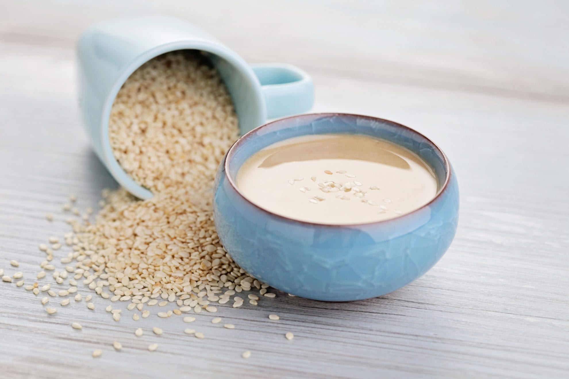 blue bowls of sesame seeds and tahini