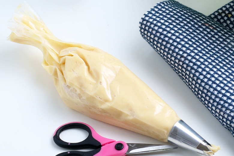 pastry bag with churro dough and star tip  