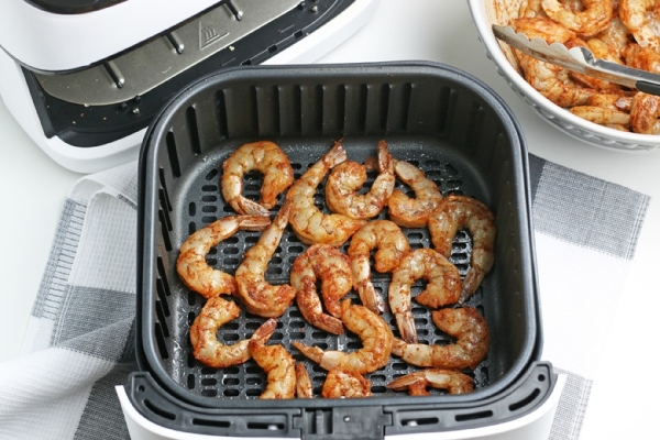 shrimp cooking in an air fryer