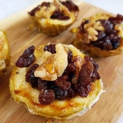 angled shot of baked apples on wooden board