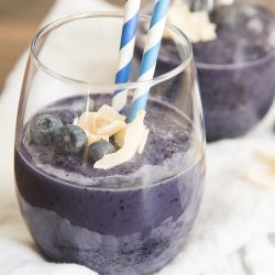 blueberry smoothie with two blue straws