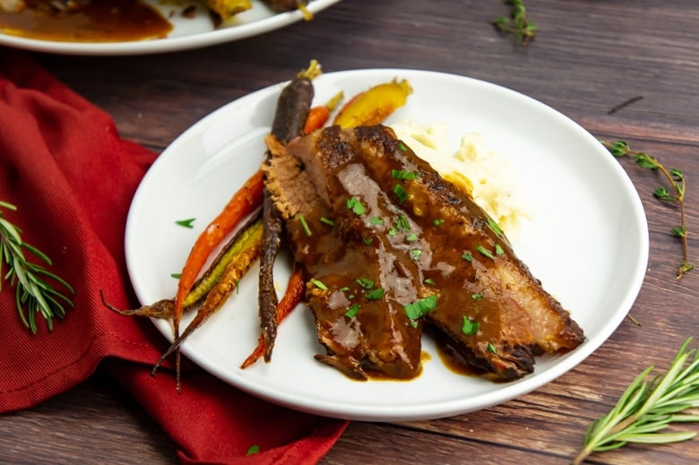 slices of brisket with carrots 