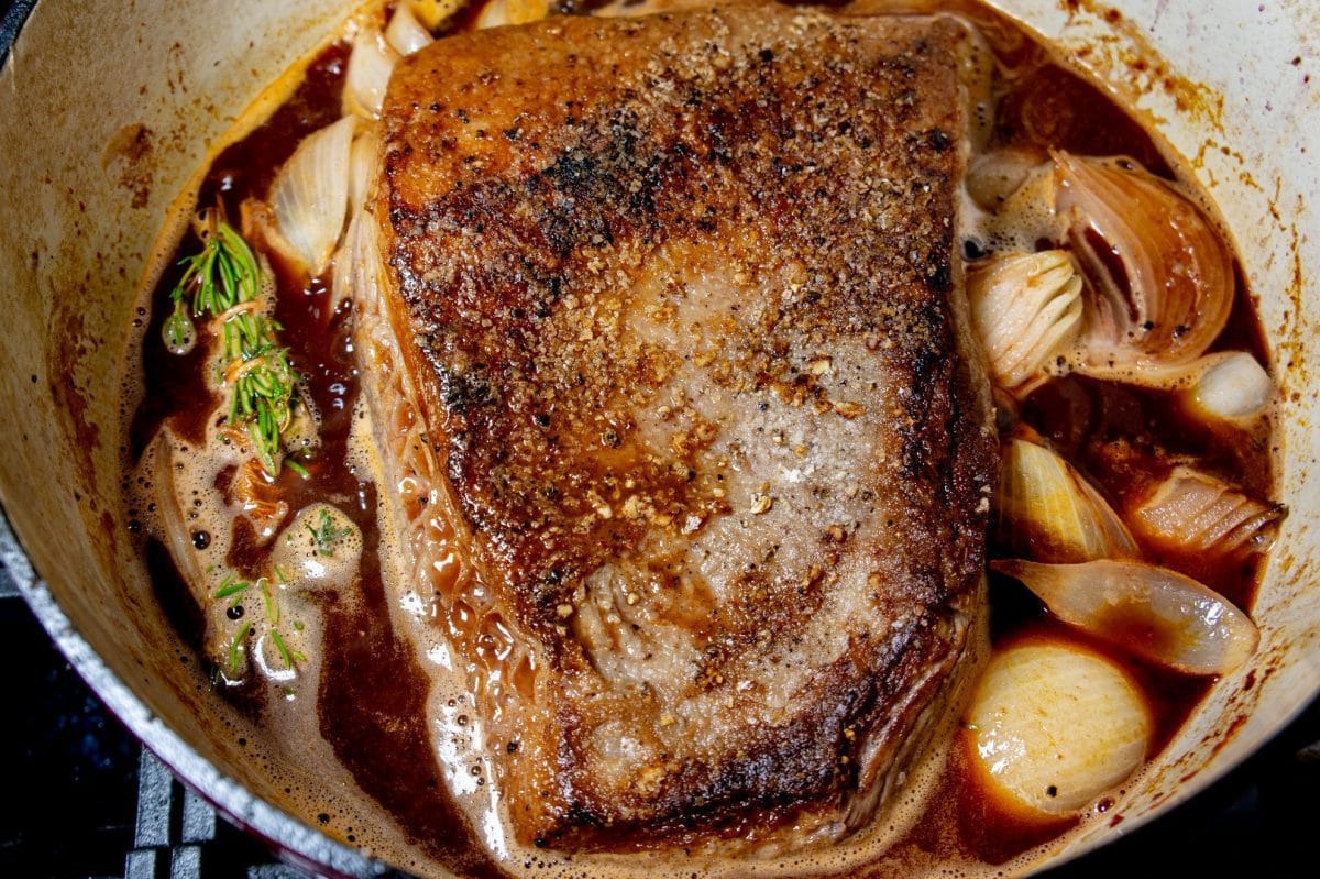 seasoned and seared brisket in a Dutch oven 