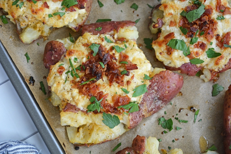 crab stuffed potatoes on a rimmed baking sheet 