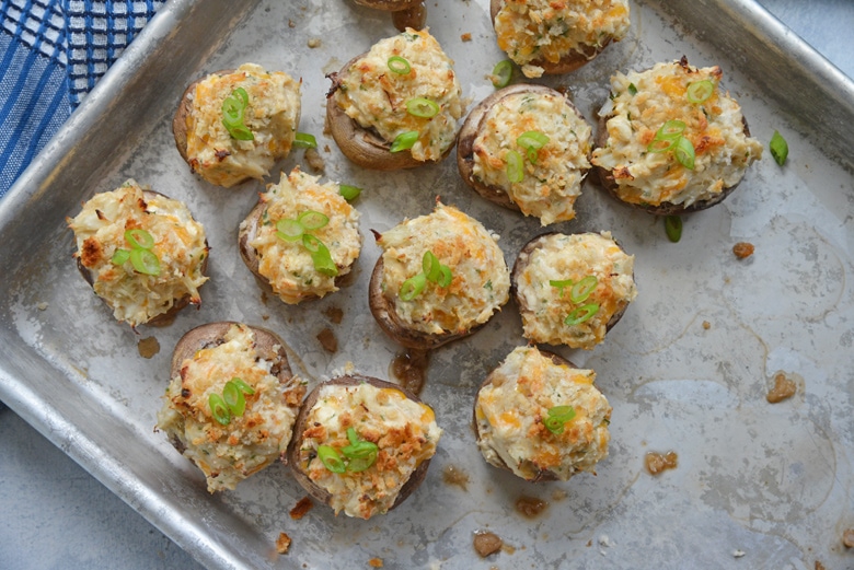 stuffed mushrooms on a baking sheet