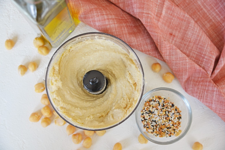 overhead of plain hummus in a blender 