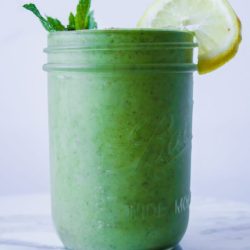straight on shot of green smoothie in mason jar